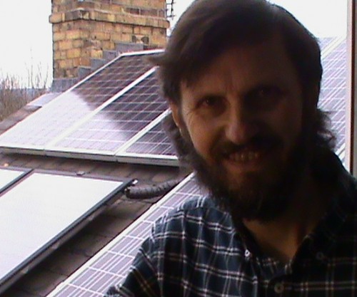 Graham Wroe with newly installed solar panels on his roof, 2010
